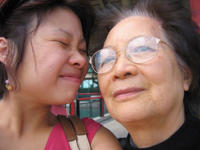 Daughter squinting and smiling at mother Daughter squinting and smiling at mother